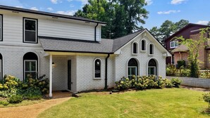 A two-story house with a covered porch and a well-maintained lawn. - Hoover Furnished Stay | Families & Pros (Birmingham)