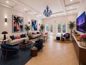 A spacious lobby with a pool view, modern furniture, and tropical artwork. - The Villas Palm Springs (Palm Springs)