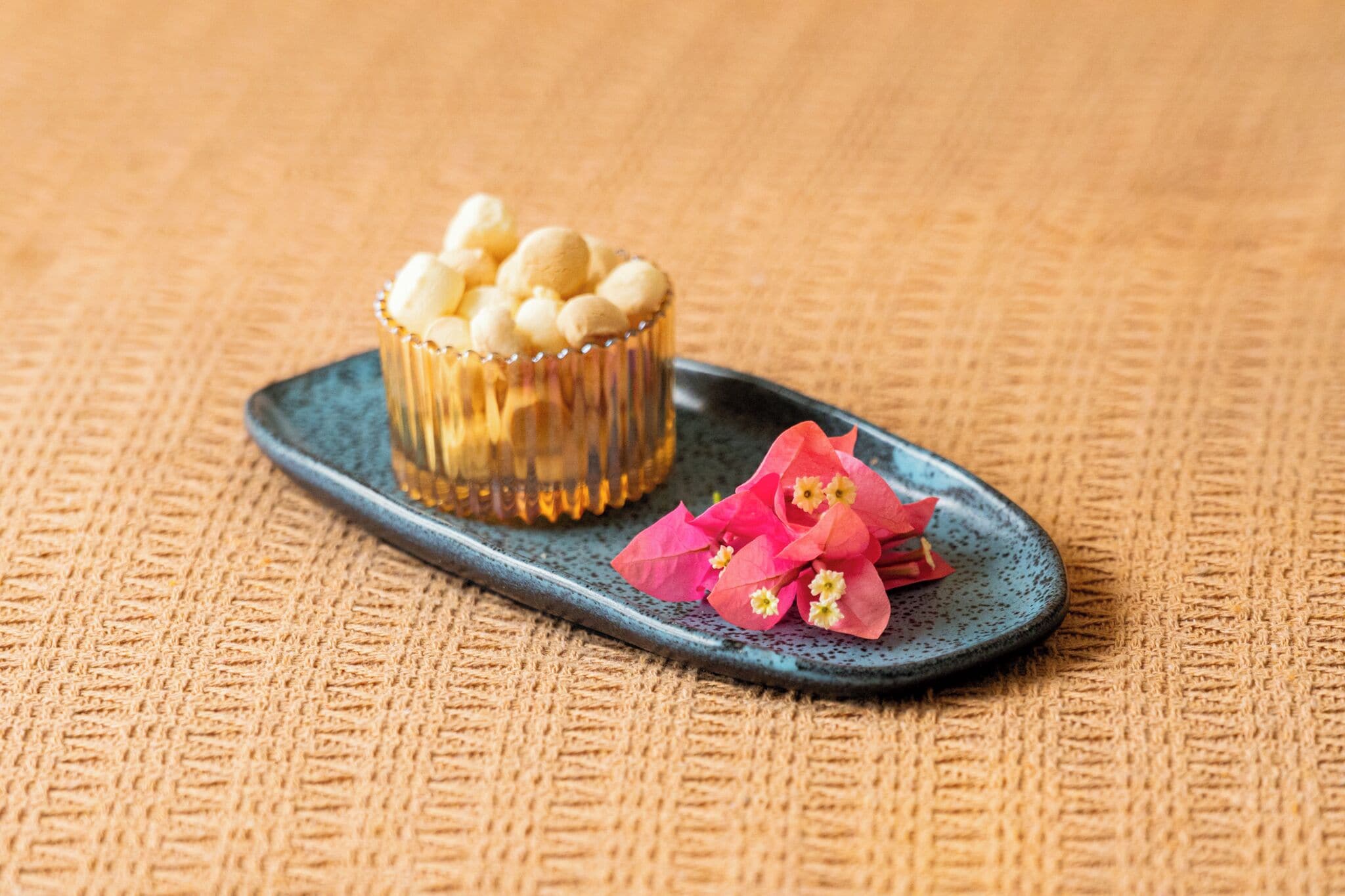A dessert with a clear glass container and a plate with pink flowers.
