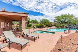 A pool area with lounge chairs, a covered seating area, and a clear sky. - 2BR Zion National Park - Hot tub - Pool (Santa Clara)