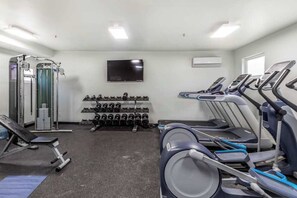 A gym with treadmills, weight machines, and dumbbells. - Stylish 1BR Zion National Park - Patio - Pool (St. George)