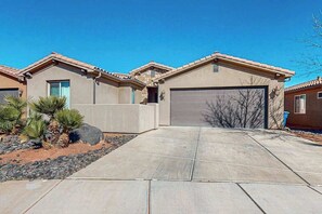A residential property with a garage, a driveway, and a landscaped area with desert plants. - 3BR home with waterpark and hot tub PV5 (Santa Clara)