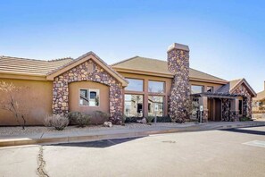 A building with a stone facade, large windows, and a flat roof. - Spacious townhome with shared pool & hot tub (Washington)