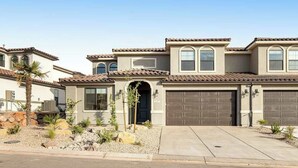 A residential building with a garage, a driveway, and a landscaped front yard. - Brand New 5BR Zion National Park - Patio (Washington)