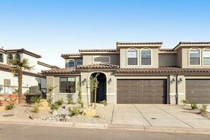 A residential building with a garage, a driveway, and a landscaped front yard. - Brand New 5BR Zion National Park - Patio (Washington)