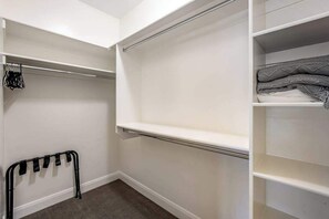 A walk-in closet with open shelves, a hanging rack, and a folded blanket on a shelf. - Brand New 5BR Zion National Park - Patio (Washington)
