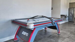 A table hockey game in a modern kitchen with a stainless steel refrigerator and cabinets. - 6BR Spacious townhouse with a pool & lazy river (Hurricane)