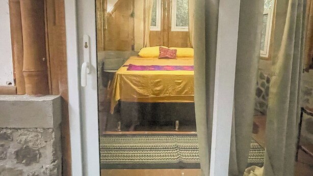 A room with a bed, a window, and a door. - Granja Tzikin (Santa Cruz La Laguna)