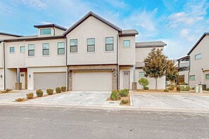 A residential building with a garage, multiple windows, and a driveway. - 4BR oasis with pool, hot tub, fire pit, & balcony (Santa Clara)