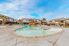 A swimming pool with lounge chairs, surrounded by residential-style buildings. - 4BR oasis with pool, hot tub, fire pit, & balcony (Santa Clara)