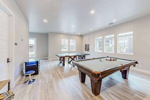 A spacious room with a pool table, a billiards table, and a small pool table. - 4BR oasis with pool, hot tub, fire pit, & balcony (Santa Clara)