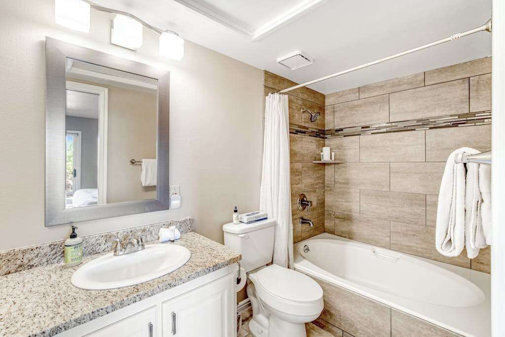 A bathroom with a sink, toilet, and bathtub.
