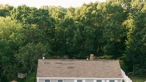 A two-story house with a front porch, a garage, and a driveway.
