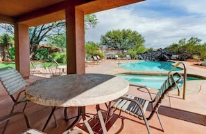 An outdoor pool area with lounge chairs and a table. - Lovely 3BR Mountainview Zion National Park 2nd-fl (Santa Clara)