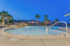A swimming pool with a no diving sign, surrounded by palm trees and houses in the background. - 3BR Mountainview Paradise Village - Pool (Santa Clara)