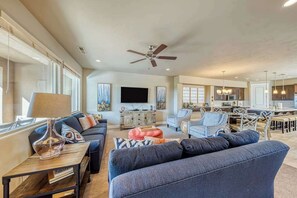 A spacious living area with a sofa, coffee table, and a television. - 3BR Mountainview Paradise Village - Pool (Santa Clara)