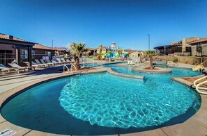 A swimming pool with lounge chairs and a water slide. - 3BR Mountainview Paradise Village - Pool (Santa Clara)