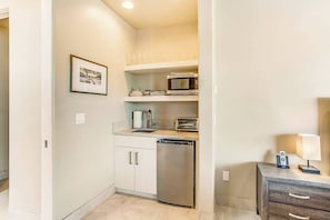 A compact kitchen with a dishwasher, microwave, and toaster. - Mountain View Studio Near Zion National Park (St. George)