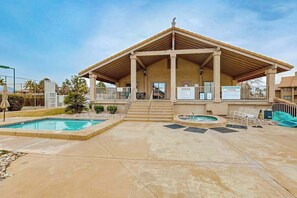 A building with a covered patio area, two swimming pools, and a hot tub. - 2BR mtn-view with pools & hot tub - near Zion (St. George)