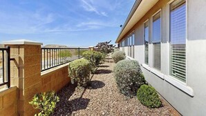 A building with a paved pathway, a metal railing, and trimmed bushes. - 3BR townhouse with hot tub and heated pool (Washington)