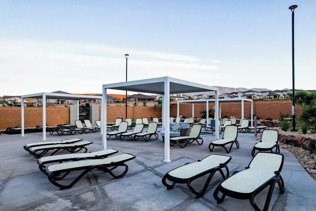 An outdoor lounge area with sun loungers and a covered seating area.