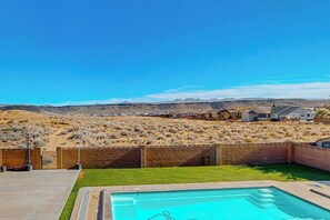 A swimming pool with a clear view of a desert landscape and a residential area in the background. - 5BR spacious home with pool, hot tub, & foosball (Hurricane)