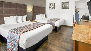 A hotel room with two beds, a desk, and a TV. - Executive Family Suite (Anaheim)