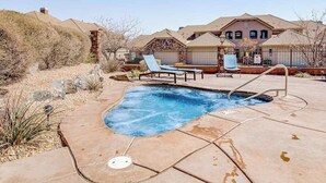 A residential property with a swimming pool, lounge chairs, and a house with a pitched roof. - 4BR mtn-view townhome with pools, hot tubs, gym (Washington)