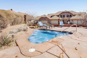 A residential property with a swimming pool, lounge chairs, and a house with a pitched roof. - 4BR mtn-view townhome with pools, hot tubs, gym (Washington)