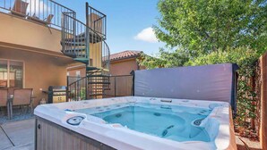 A hot tub in a backyard with a wooden deck, a staircase, and a patio area. - 5BR home with waterpark, private pool and spa (Santa Clara)