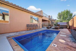 A swimming pool area with a clear blue pool, a covered seating area, and a staircase leading to an upper level. - 5BR home with waterpark, private pool and spa (Santa Clara)
