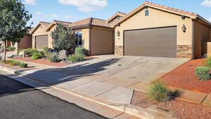 A residential property with a paved driveway, a garage, and landscaped garden beds. - 5BR home with waterpark, private pool and spa (Santa Clara)