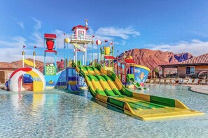 A water park with multiple slides and water features, surrounded by mountains. - 5 BR home with hot tub & water park PV90 (Santa Clara)