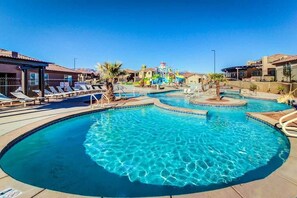 A swimming pool with multiple lanes, lounge chairs, and a water slide. - 5 BR home with hot tub & water park PV90 (Santa Clara)