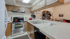 A compact kitchen with a stove, oven, microwave, and a sink. - Eagle's Rest - Huntington Lake (Lakeshore)