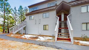 A two-story building with a staircase leading to the entrance. - Huntington Hideaway - Huntington Lake (Lakeshore)