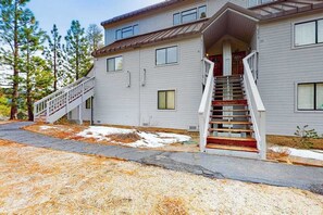 A two-story building with a staircase leading to the entrance. - Huntington Hideaway - Huntington Lake (Lakeshore)