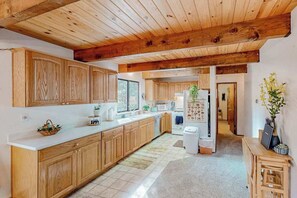 A kitchen with wooden cabinets, a white countertop, and a wooden ceiling. - Forest Retreat - Blue Lake Springs (Arnold)