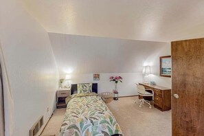 A bedroom with a bed, bedside table, lamp, desk, chair, and a door. - Forest Retreat - Blue Lake Springs (Arnold)