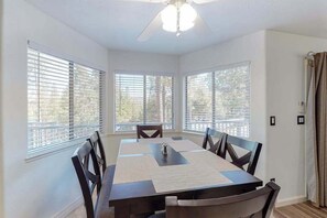 A dining area with a table, chairs, and a ceiling fan. - Holiday Chalet - Pine Mountain Lake (Groveland)