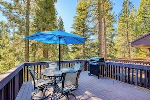 A deck with a table and chairs, a grill, and an umbrella. - Weekend at the Lake - Huntington Lake (Lakeshore)