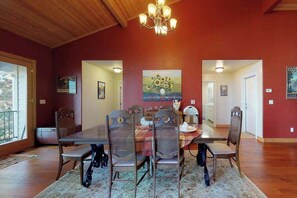 A dining room with a wooden ceiling, a chandelier, and a table set for four. - Pine Mountain Getaway - Pine Mountain Lake (Groveland)