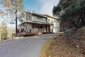 A two-story house with a covered porch, a garage, and a satellite dish. - Pine Mountain Getaway - Pine Mountain Lake (Groveland)