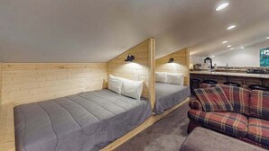 A compact room with two beds, a sofa, and a kitchenette. - Tranquil Pines Estate - Ridgetop (Shaver Lake)
