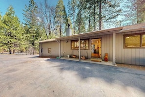 A single-story building with a covered porch, a chimney, and a driveway. - Piney Point - Meadowmont (Arnold)