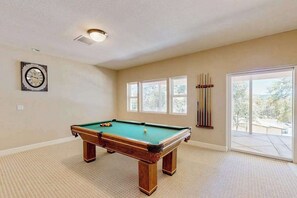 A room with a pool table, a clock on the wall, and a window with a view. - Hemlock Hacienda - Pine Mountain Lake (Groveland)