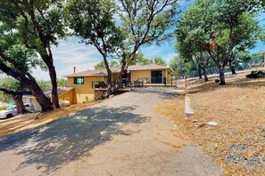 A two-story building with a driveway leading to a gated entrance. - Walling Mountain Retreat - Pine Mountain Lake (Groveland)