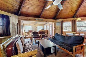 A wooden interior with a sofa, chairs, and a table. - Rustic Retreat - Pine Mountain Lake (Groveland)
