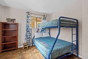 A bunk bed with a blue metal frame, a wooden shelf unit, and a small stool. - Big Trees, Little Cabin - Meadowmont (Arnold)