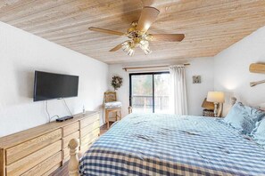 A bedroom with a bed, a television, a wooden dresser, a ceiling fan, and a window with curtains. - Forest With A View - Musick Falls (Shaver Lake)